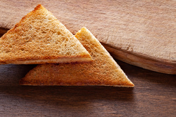 pieces of toast bread on a wooden background