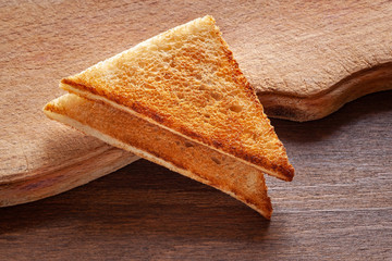 Slices of toast bread on a wooden background