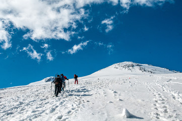 Fototapeta na wymiar tourists in the snowy Caucasus mountains in July