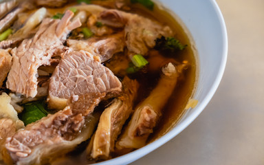 Close up of a bowl of meat noodle with beef soup