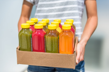 Bottles of juice with fruits and vegetables in delivery box. Cold pressed juicing bottles. Healthy juices for detox.