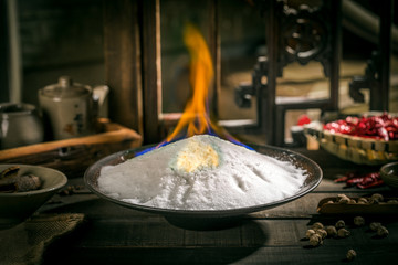 Dry the salt over a flame in a dark dish