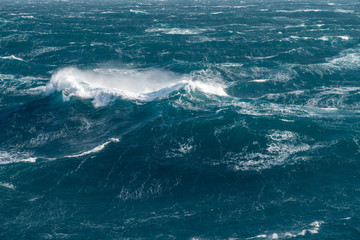 View from cabin balconies at the rough seas and waves off the side of cruise ship