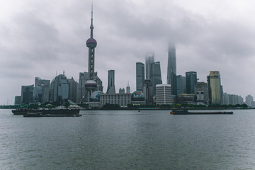  Shanghai / China - may 22 2017: Shanghai skyline on a cloudy day with the skyscrapers covered in louds and mist 