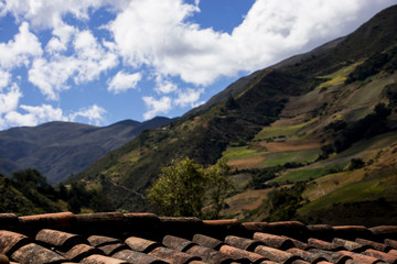 Beautiful country mountains with crops seen over a ceramic tile peasant roof