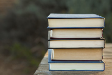 Pile of closed books outdoors