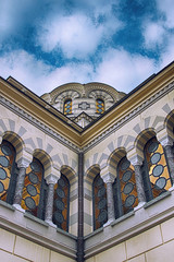 Obraz premium Beautiful white stone church with gold cupolas , blue sky with clouds