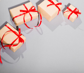 gifts on a gray background a lot lies isolate with a red bow surprise surprise postcard place for...