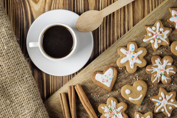 homemade gingerbread cookie and coffee on a wooden background. top view