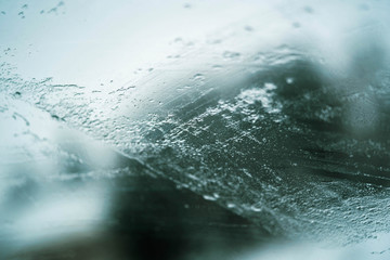 Glass Window Covered With Ice And Rain Drops