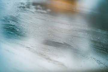 Glass Window Covered With Ice And Rain Drops