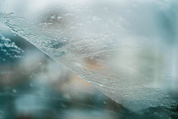 Glass Window Covered With Ice And Rain Drops