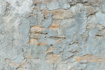 Old wall of old stones with plaster. Stonework texture. Grunge background. Template and mockup for designers.