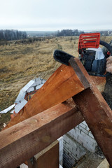 Workers cut the rafters on the roof of the chainsaw house