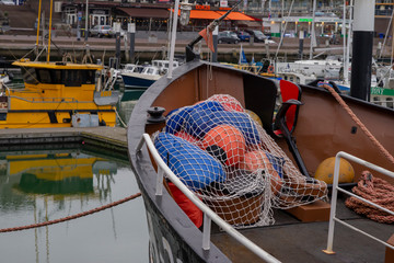 Fototapeta na wymiar SCHEVENINGEN, NETHERLANDS – January 07, 2019: Yachts and fishing ships in Scheveningen marina