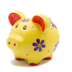 Yellow ceramic piggy bank on white background