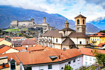 Fototapeta premium Beautiful ancient city of Bellinzona in Switzerland with Collegiata dei Ss. Pietro e Stefano church and Castelgrande castle on background