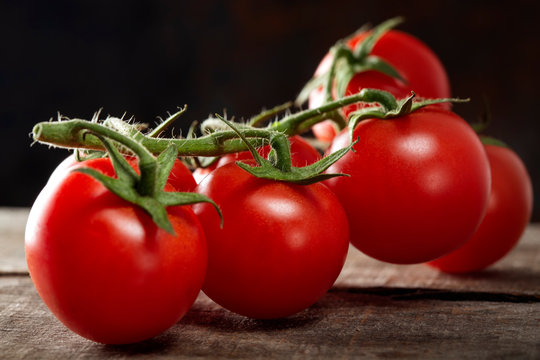 Fresh row cherry tomatoes on wood