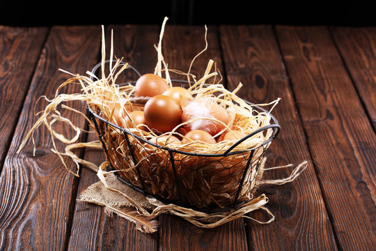 Egg. Fresh farm eggs in basket. Easter egg with feather concept