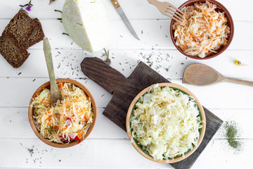 Sauerkraut in plates on the table, top view. 