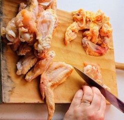 Cook preparing chicken meat