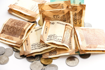 Close up view of indian banknotes and coins on white background.