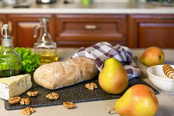 The process of cooking bruschetta with pear, honey, walnut, cheese, green salad and olive oil