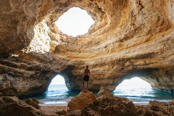 Man standing in the Benagil caves in southern Portugal