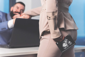 Boss felicitating to his pregnant employee