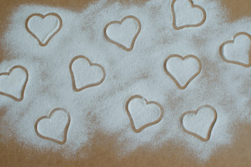 on a wooden board hearts of powdered sugar
