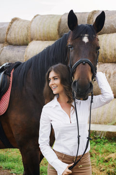 Young woman rider and her beautiful horse