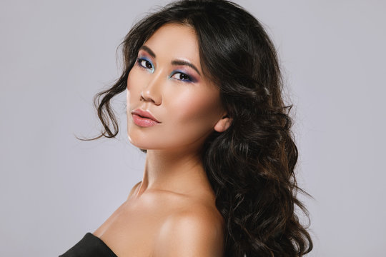Young asian woman with a beautiful curly hair and make-up