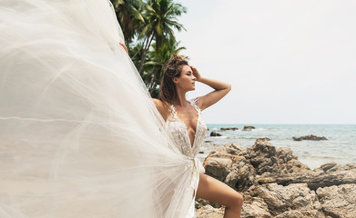 Bride wearing beautiful wedding dress on the tropical beach