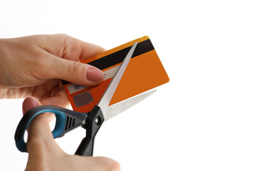 Woman cutting her credit card with a scissors