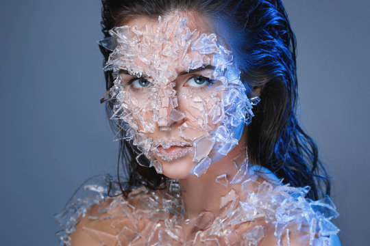 Female Face Covered With A Lot Small Pieces Of Glass Or Ice