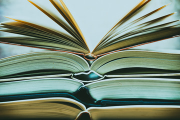 Several textbooks with white sheets opened in the middle