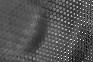 Shiny metal mesh dark background close-up