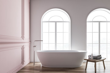 Pink and white bathroom interior, tub