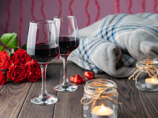 Romantic cozy evening with wine, flowers, candles and present
