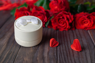 Obraz na płótnie Canvas Ring box gift with beautiful bouquet of red roses, romantic evening