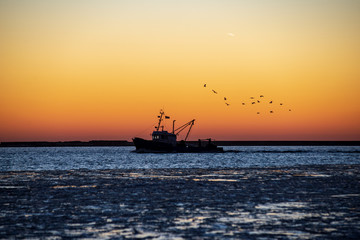 dramatic red sunset over the frozen sea on the beach