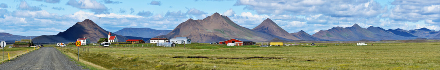 Fototapeta na wymiar Panorama of Modrudalur farm, green grassland and Modrudalsjallgardar mountains at right
