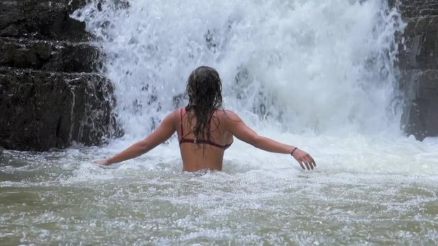 Slow Motion: Beautiful Woman Bathing at the Bottom of Waterfall