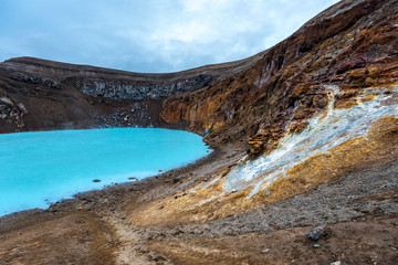 Walls of Viti crater with geothermal lake at Askja caldera in midnight lights of Iclandic summer