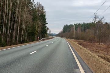 Fototapeta premium country gravel road with old and broken asphalt