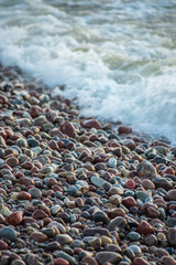 abstract details of rocky beach pebbles in sunset by the sea