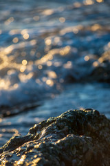abstract details of rocky beach pebbles in sunset by the sea