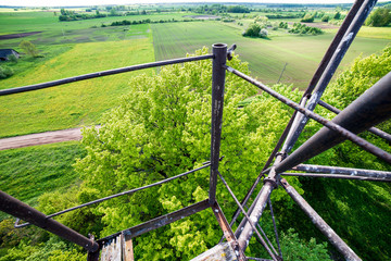 Fototapeta premium watchtower details and wooden bars, stairs and walls from below up