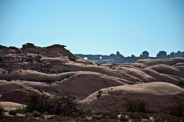 Fototapeta premium Hills with arches behind in Arches National Park, USA