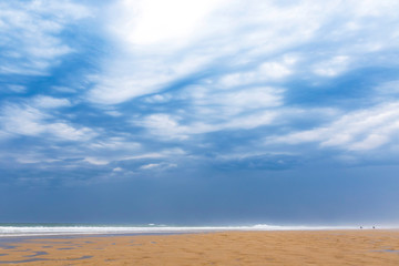 Fototapeta na wymiar Ocean beach on the Atlantic coast of France near Lacanau-Ocean, Bordeaux, France. Windy and cloudy summer day
